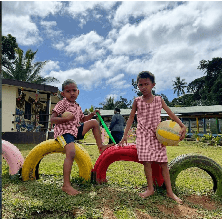 Two young children at a school playground in Fiji