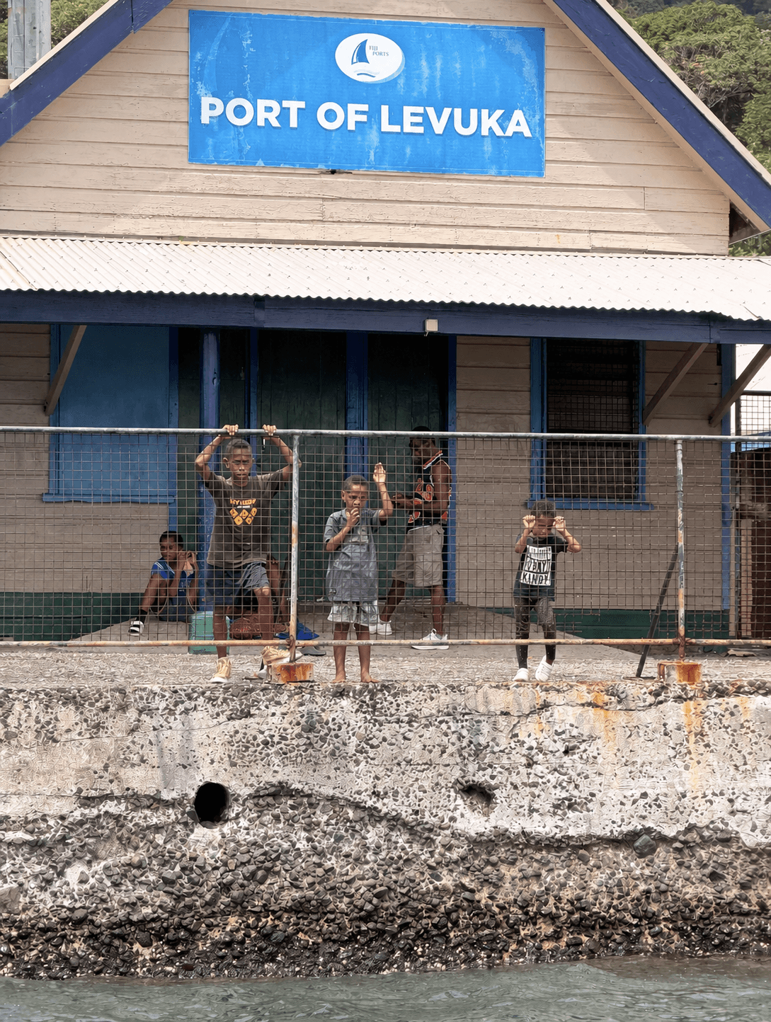 Children standing outside the Port of Levuka building in Fiji
